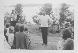 John playing during campfire songs by the lake