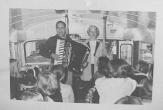 John on camp bus with accordion leading song fest